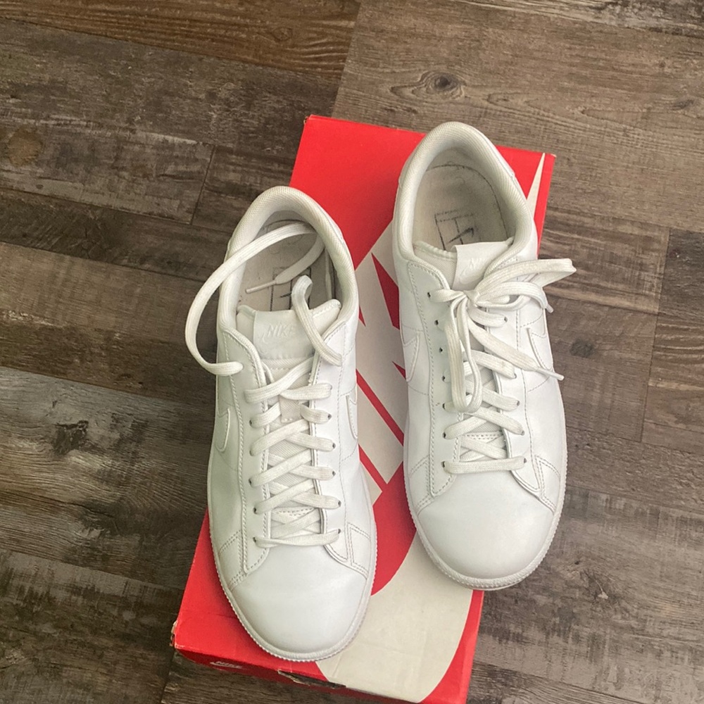 White Nike sneakers. Worn… still tons of wear left. Needs cleaning